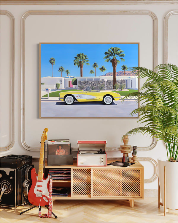 A tribute to "Don't Worry Darling", a stylish mid-century room features artwork of a classic convertible outside a Palm Springs home.