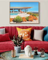 A chic and modern living space featuring a captivating artwork of a woman lounging poolside on a sunny day with the Los Angeles skyline in the backdrop