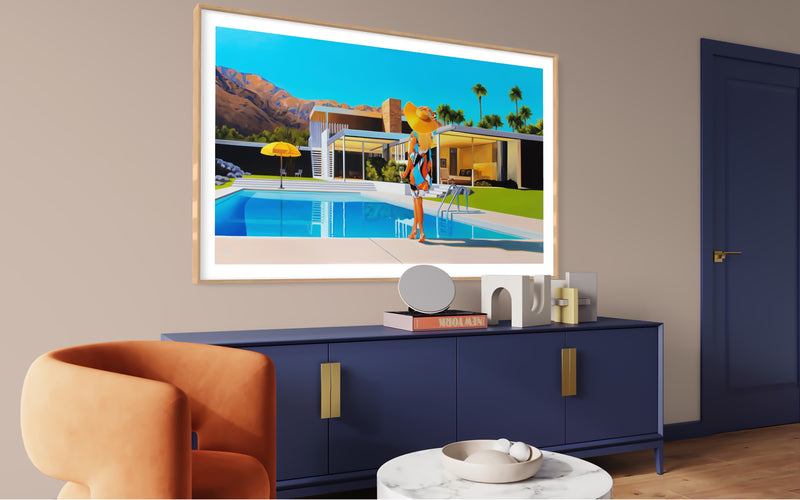 Stylish mid-century decor features artwork inspired by Slim Aarons Poolside Gossip & Kaufmann house. Woman in floppy hat relaxes poolside on sunny day