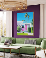 Midcentury modern art takes center stage in this stylish living room. The artwork depicts a pink Cadillac and a midcentury-style house, with palm trees in the distance. Chic and sophisticated