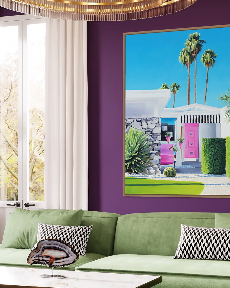 A vibrant piece of art in a chic living room. The midcentury architecture and pink Cadillac create a vintage vibe, while the swaying palm trees add a touch of relaxation. A true statement piece