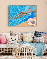 A stunning artwork in a chic living room featuring a young girl in a colorful bikini, swimming in a luxurious pool.