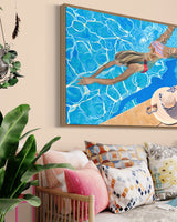 A captivating artwork in a fashionable living room showcasing a young girl in a cheerful bikini, playing in a gorgeous pool