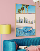 The beauty of desert living is captured in this stunning artwork, with pool floats adding a touch of whimsy to a stylish living room